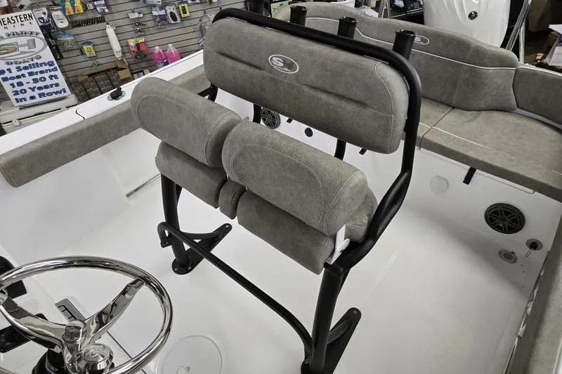 Slide: The Image of 2025 Sea Hunt Ultra 229 boat interior with cushioned seating and steering wheel. - 10