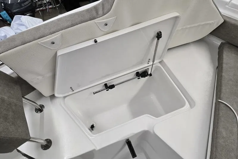 Slide: The Image of Open storage compartment on 2025 Sea Hunt Ultra 229 boat, featuring cushioned seating. - 13