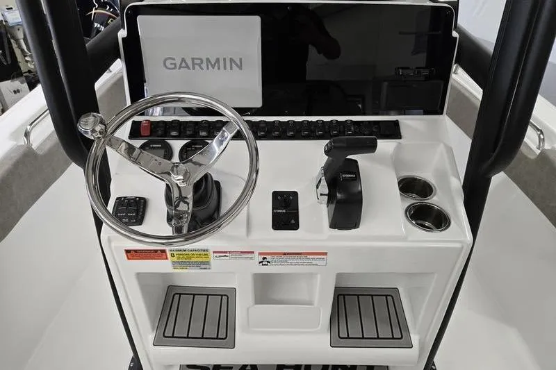 Slide: The Image of 2025 Sea Hunt Ultra 229 boat console with Garmin navigation, steering wheel, and controls. - 14