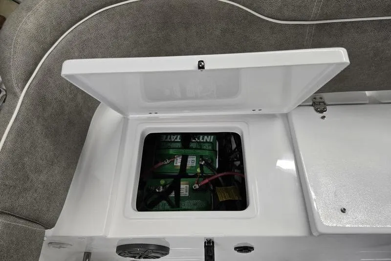 Slide: The Image of Open battery compartment on 2025 Sea Hunt Ultra 229 boat, showing internal components. - 15