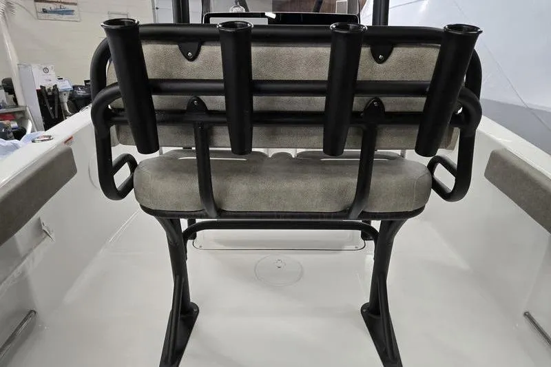 Slide: The Image of 2025 Sea Hunt Ultra 229 boat interior with rod holders and cushioned seating. - 17