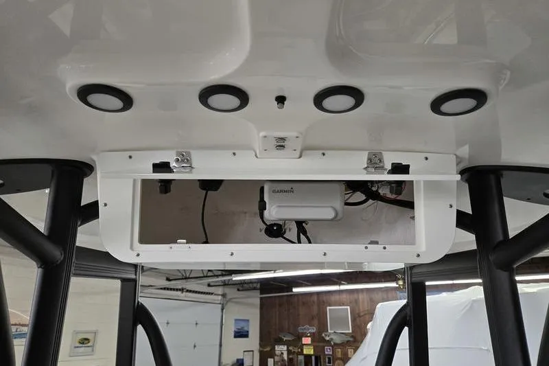 Slide: The Image of 2025 Sea Hunt Ultra 229 boat console with electronic equipment and storage compartment. - 18