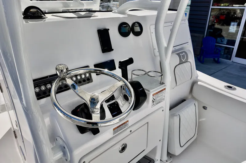 Slide: The Image of 2026 Sea Fox 248 Side Console boat dashboard with steering wheel and controls. - 11