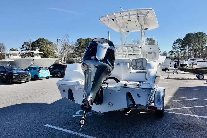 Slide: The Image of 2026 Sea Fox 248 Side Console boat with outboard motor in a parking lot. - 17