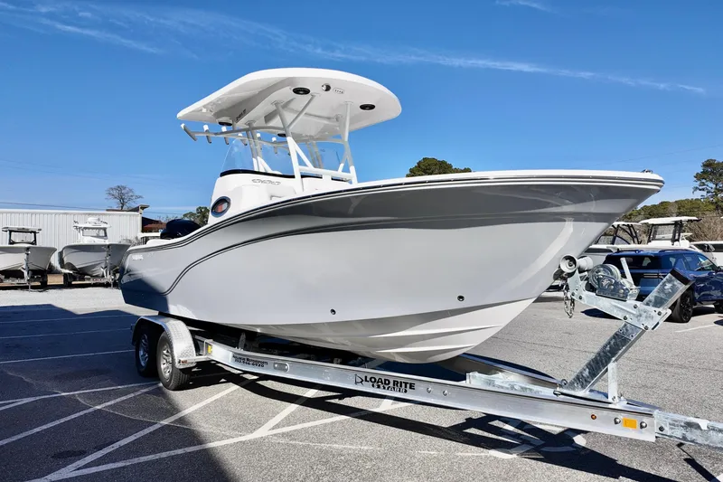 Slide: The Image of 2026 Sea Fox 248 Side Console boat on trailer, parked outdoors under clear sky. - 18