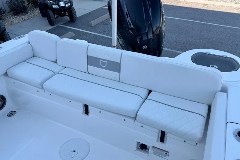 Slide: The Image of 2026 Sea Fox 248 Side Console boat with white cushioned seating and outboard motor. - 20