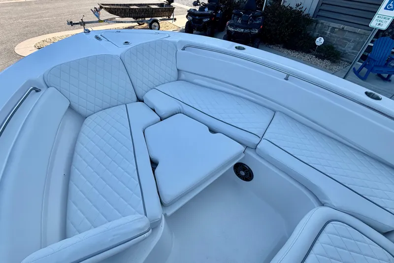 Slide: The Image of 2026 Sea Fox 248 Side Console boat with white quilted seating and table. - 22