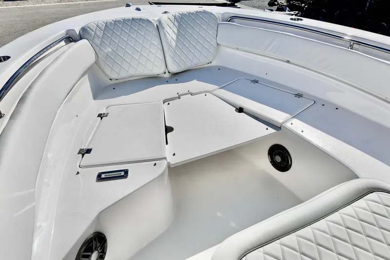 Slide: The Image of 2026 Sea Fox 248 Side Console boat interior with white cushioned seating and storage compartments. - 5