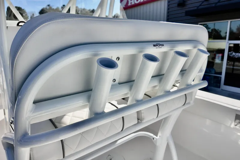 Slide: The Image of 2026 Sea Fox 248 Side Console boat with rod holders and cushioned seating. - 6