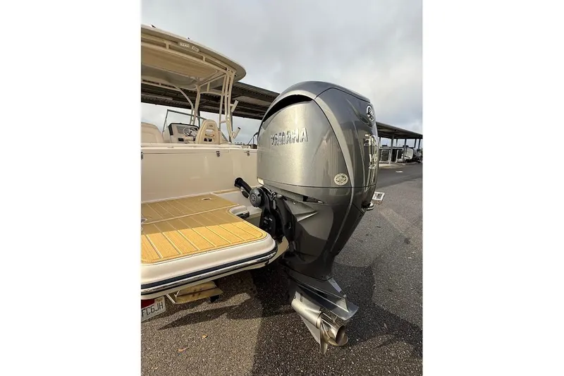 Slide: The Image of 2022 Grady-White Freedom 235 boat with Yamaha outboard motor, docked on a sunny day. - 12