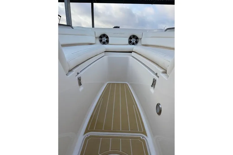 Slide: The Image of Interior view of 2022 Grady-White Freedom 235 boat with cushioned seating and speakers. - 16