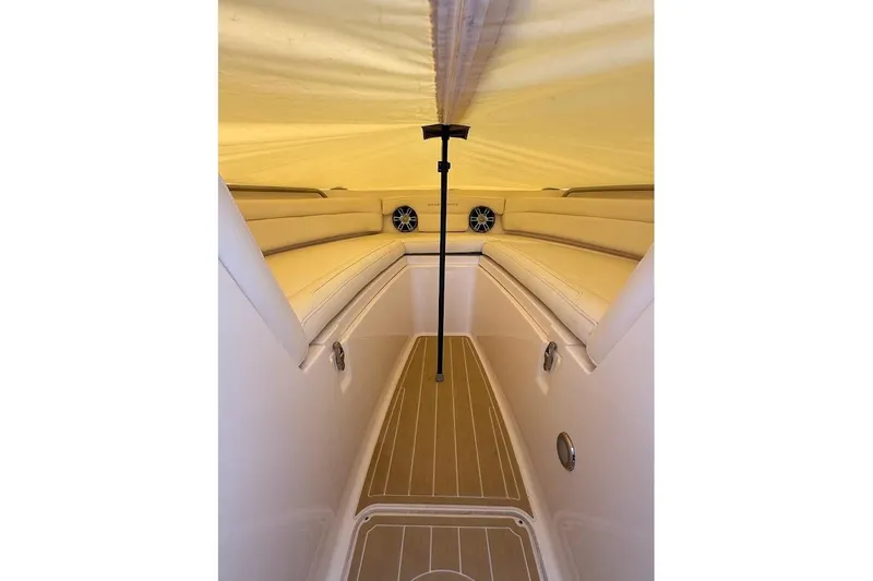 Slide: The Image of Interior view of 2022 Grady-White Freedom 235 boat with cushioned seating and speakers. - 17