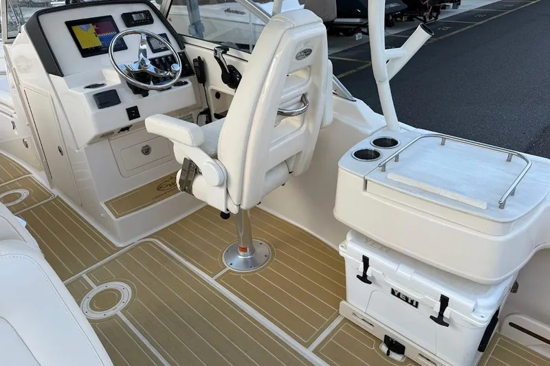 Slide: The Image of 2022 Grady-White Freedom 235 boat interior with helm, seating, and storage. - 19