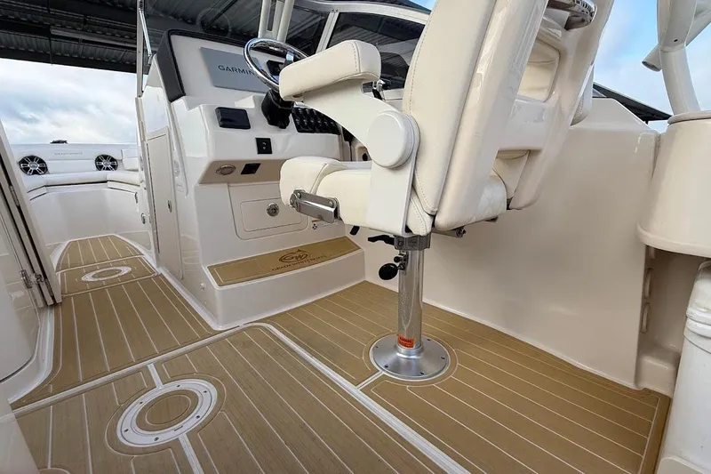 Slide: The Image of 2022 Grady-White Freedom 235 boat interior with helm and seating area. - 20