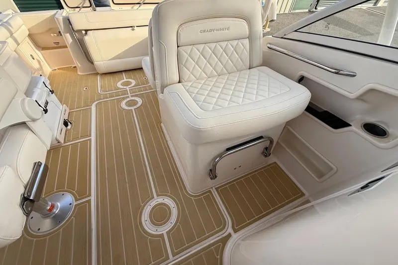 Slide: The Image of 2022 Grady-White Freedom 235 boat interior with luxurious seating and teak-style flooring. - 26
