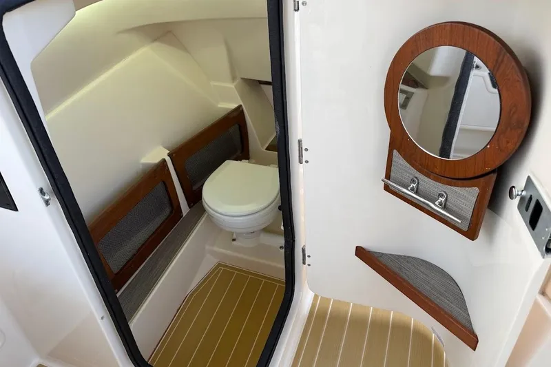 Slide: The Image of 2022 Grady-White Freedom 235 boat interior with toilet and mirror. - 28