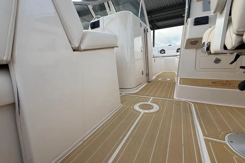 Slide: The Image of 2022 Grady-White Freedom 235 boat interior with sleek seating and wood-patterned flooring. - 30