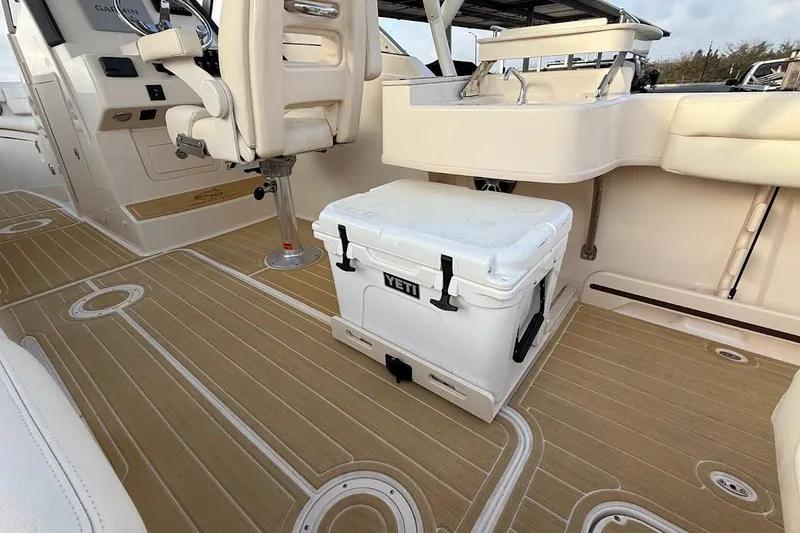 Slide: The Image of 2022 Grady-White Freedom 235 boat interior with YETI cooler and seating. - 33