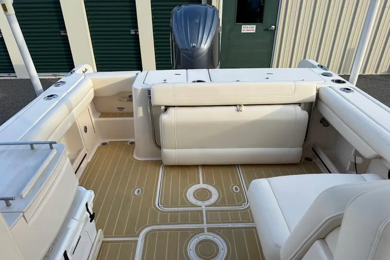 Slide: The Image of 2022 Grady-White Freedom 235 boat interior with beige seating and flooring. - 34