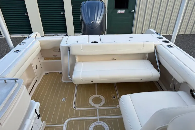 Slide: The Image of 2022 Grady-White Freedom 235 boat interior with white seating and teak-style flooring. - 35