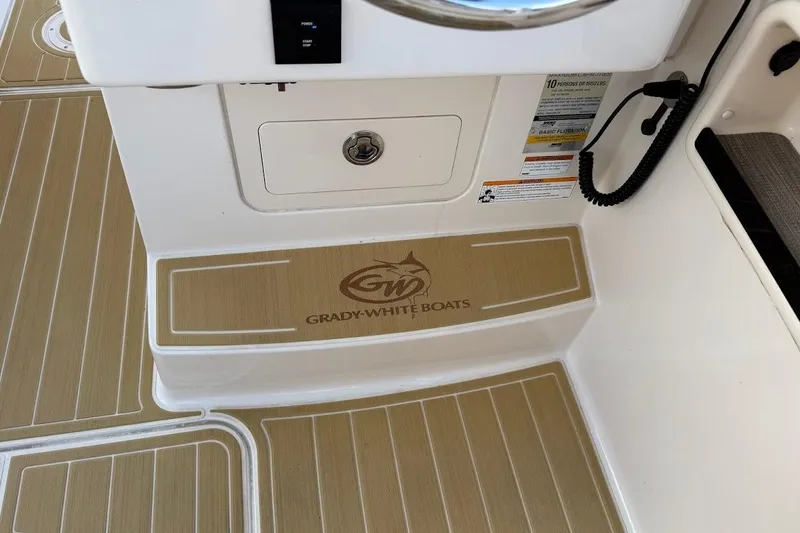 Slide: The Image of 2022 Grady-White Freedom 235 boat interior with branded flooring and control panel. - 41