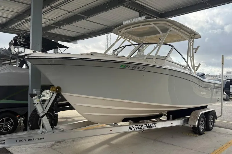 Slide: The Image of 2022 Grady-White Freedom 235 boat on trailer in covered storage area. - 47