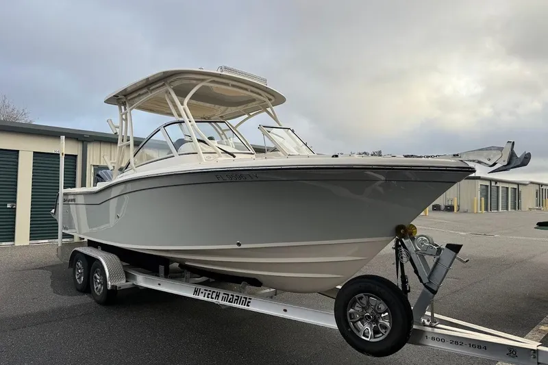 Slide: The Image of 2022 Grady-White Freedom 235 boat on trailer, parked near storage units. - 6