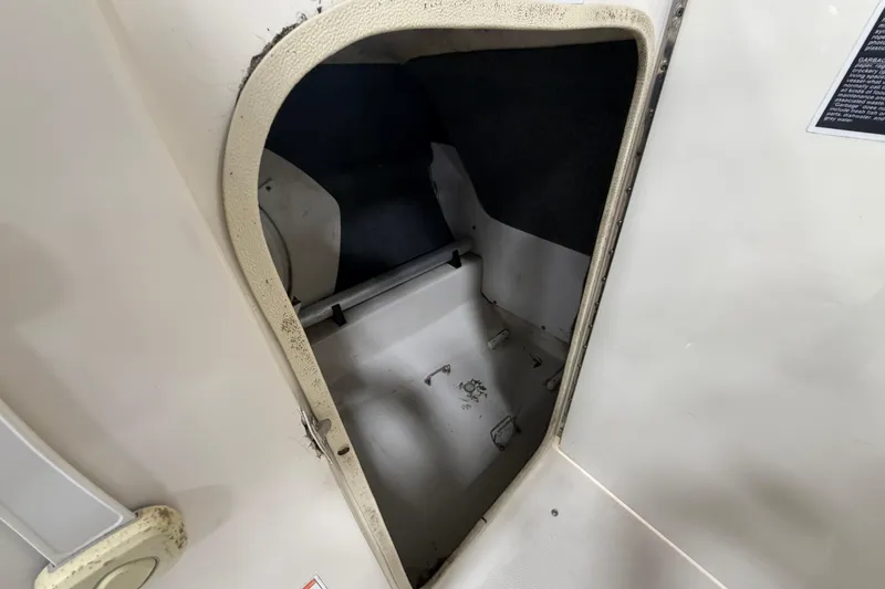 Slide: The Image of Storage compartment inside 2006 Sea Ray 200 Sundeck boat, showing interior details. - 11