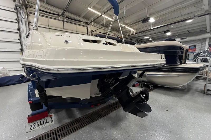 Slide: The Image of 2006 Sea Ray 200 Sundeck boat in indoor storage, rear view with propeller. - 3