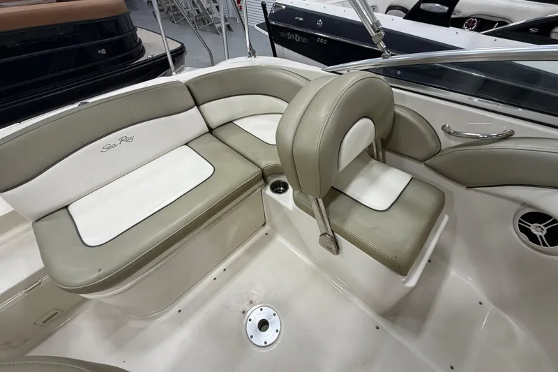 Slide: The Image of 2006 Sea Ray 200 Sundeck interior with beige and white seating. - 7