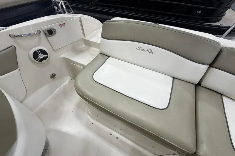 Slide: The Image of 2006 Sea Ray 200 Sundeck interior seating with speaker and storage compartment. - 8