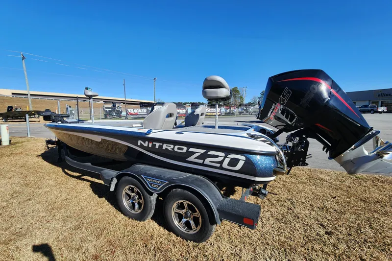 Slide: The Image of 2023 Nitro Z20 boat on trailer, parked outdoors under clear blue sky. - 4