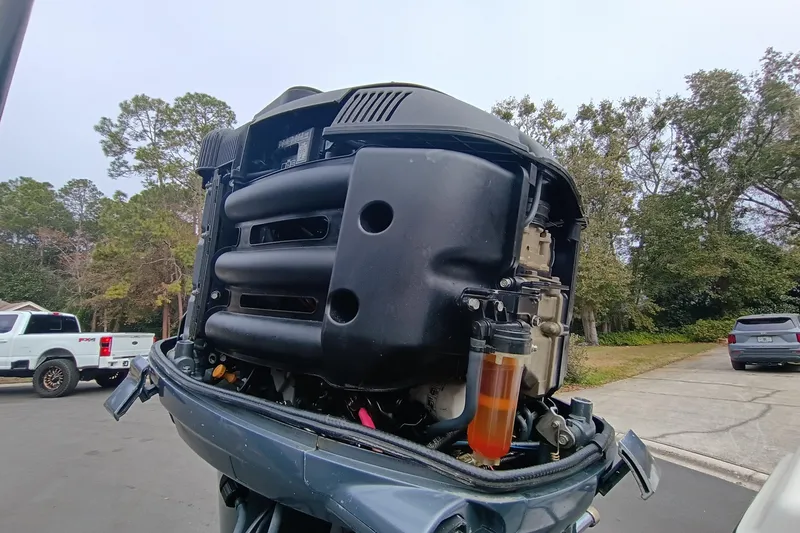 Slide: The Image of 2006 ShearWater Z2200 outboard motor with visible fuel filter, parked in a residential area. - 10
