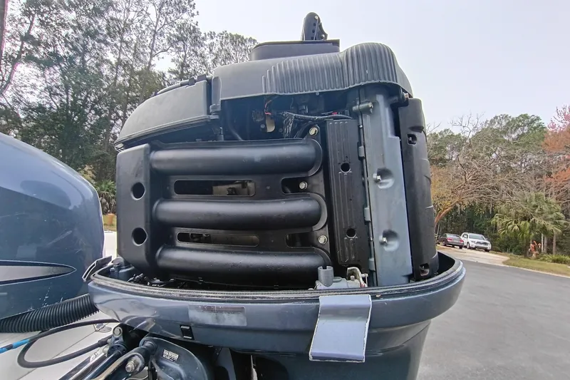 Slide: The Image of 2006 ShearWater Z2200 outboard motor with open engine cover, showing internal components. - 12