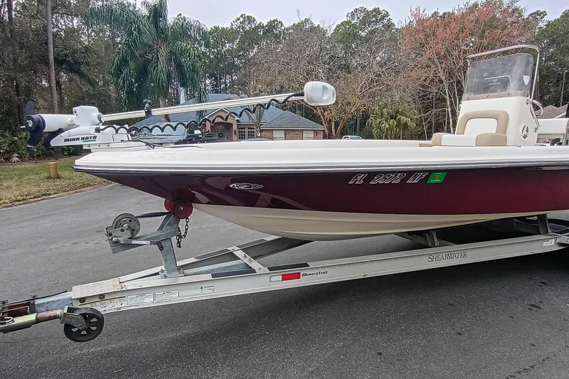 Slide: The Image of 2006 ShearWater Z2200 boat on trailer, parked on residential street. - 15