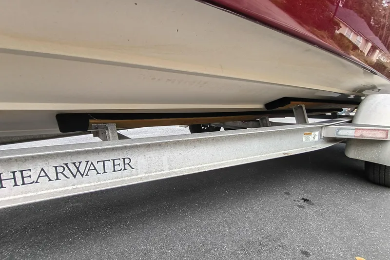 Slide: The Image of 2006 ShearWater Z2200 boat on trailer, close-up view of hull and trailer details. - 17