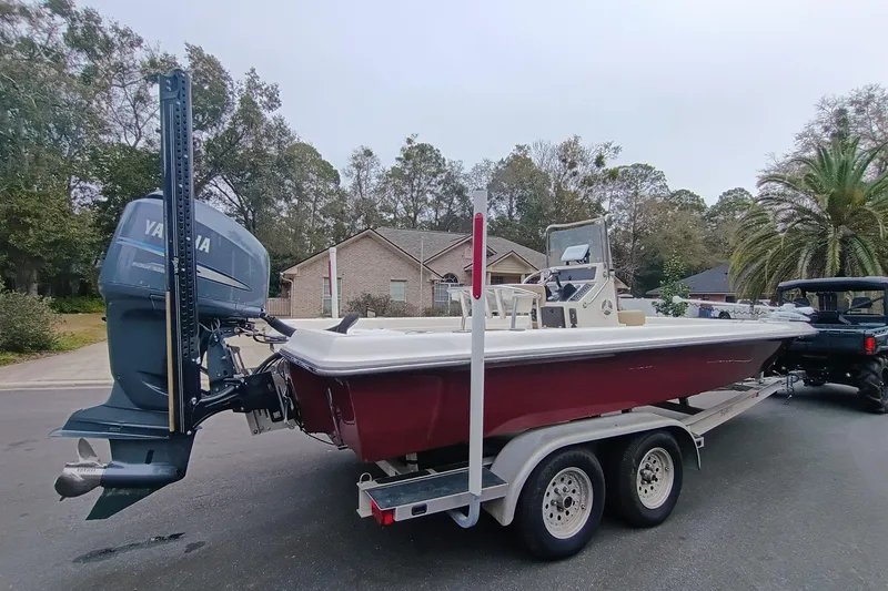 Slide: The Image of 2006 ShearWater Z2200 boat on trailer with Yamaha outboard motor in residential area. - 23