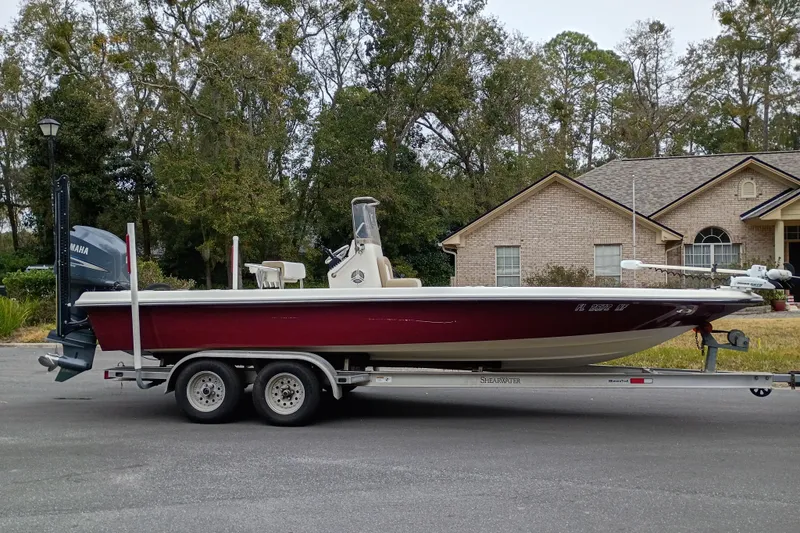 Slide: The Image of 2006 ShearWater Z2200 boat on trailer, parked in residential area. - 24