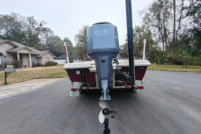 Slide: The Image of 2006 ShearWater Z2200 boat with 250 HP engine on a residential street. - 25