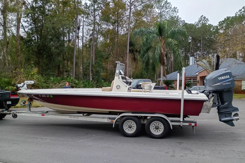 Slide: The Image of 2006 ShearWater Z2200 boat on trailer with Yamaha outboard motor, parked on street. - 29