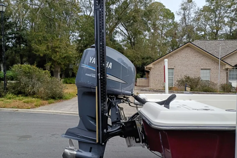 Slide: The Image of 2006 ShearWater Z2200 boat with Yamaha outboard motor, parked in residential area. - 32