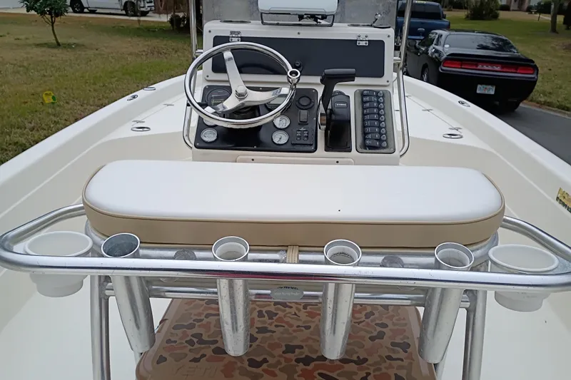 Slide: The Image of Center console of a 2006 ShearWater Z2200 boat with steering wheel and controls. - 35