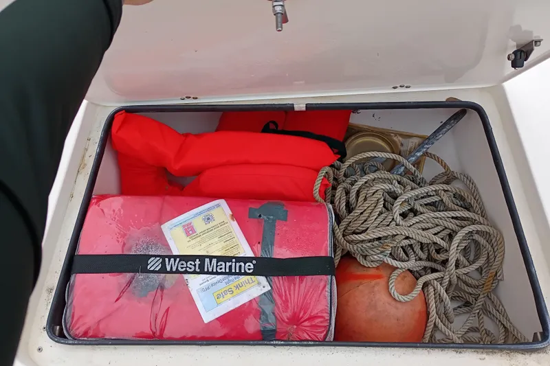 Slide: The Image of Storage compartment in a 2006 ShearWater Z2200 boat with life jackets, rope, and buoy. - 38