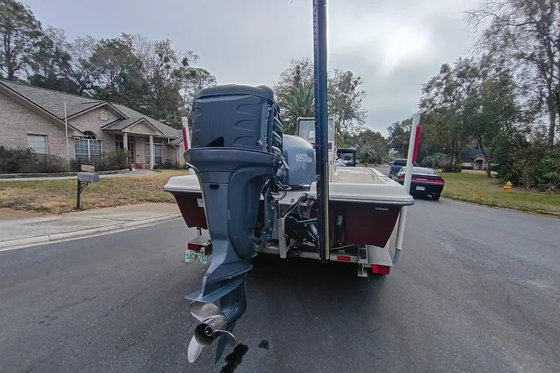 Slide: The Image of 2006 ShearWater Z2200 boat with outboard motor on a residential street. - 4