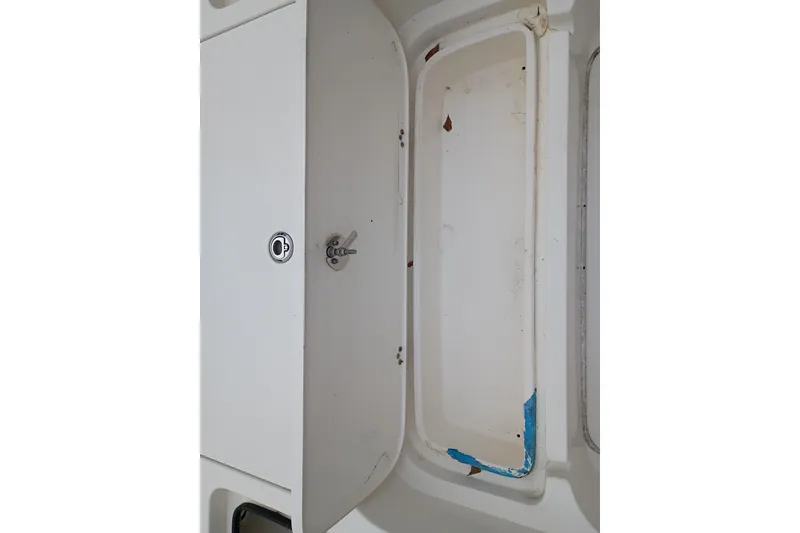 Slide: The Image of 2006 ShearWater Z2200 boat storage compartment with visible wear and blue paint. - 42