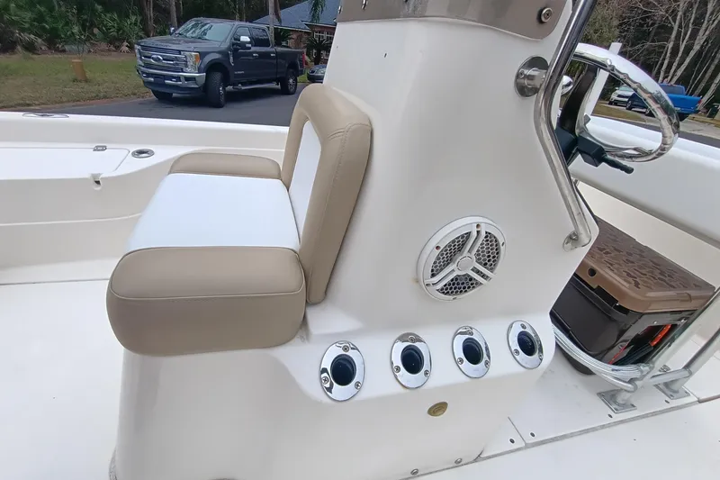 Slide: The Image of 2006 ShearWater Z2200 boat interior with beige seating and control panel. - 44