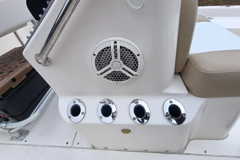 Slide: The Image of 2006 ShearWater Z2200 boat console with speaker and rod holders. - 47