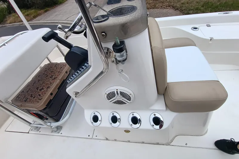 Slide: The Image of 2006 ShearWater Z2200 boat interior with beige seating and control panel. - 48