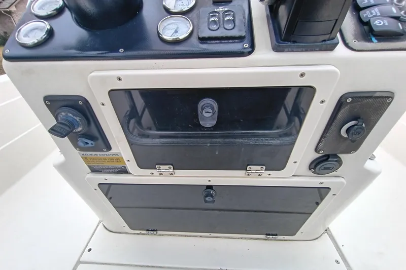 Slide: The Image of Control panel of a 2006 ShearWater Z2200 boat with gauges and switches. - 53