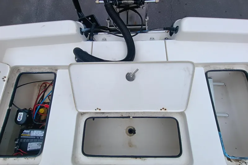 Slide: The Image of 2006 ShearWater Z2200 boat interior with storage compartments and wiring. - 55
